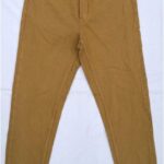 Mustard yellow high-waisted jeans with a slim tapered fit.