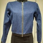 Blue denim bomber jacket with black ribbed collar and zipper closure.