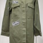 Olive green cropped military-style jacket with embroidered bird details.
