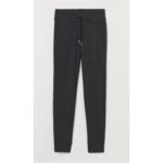 A pair of dark grey jogger pants with a drawstring waist and cuffed ankles.