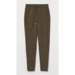 A pair of olive green jogger pants with an elastic waistband and drawstring.