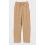 A pair of beige casual pants with an elastic waistband and drawstring.